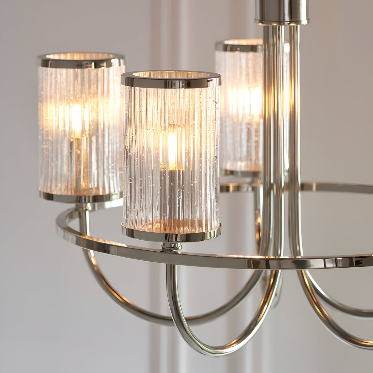 Close-up of Endon Brenfield 5 Light Pendant in nickel, showing curved arms and clear ribbed cylindrical glass shades with bubble detail.