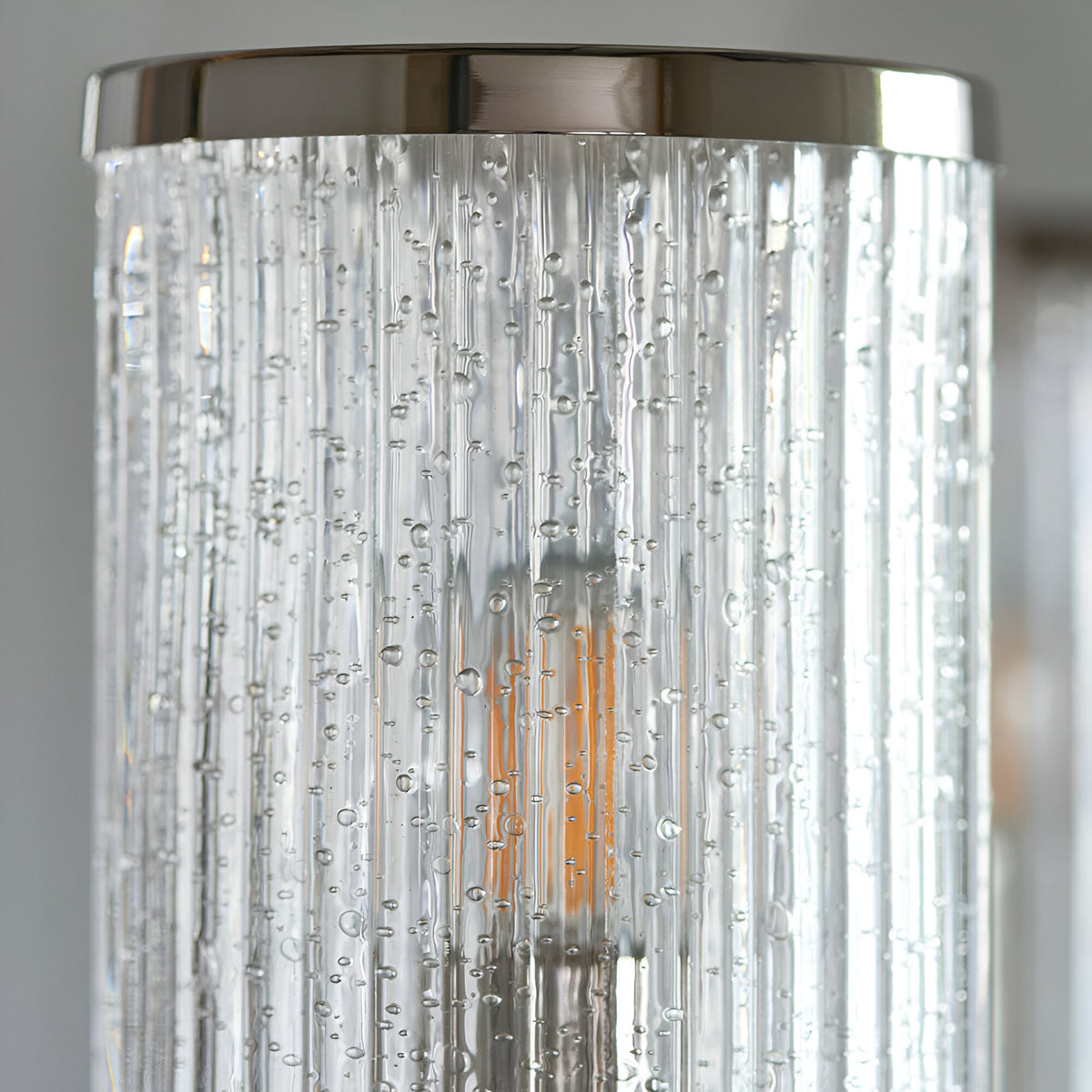 Close-up of Endon Brenfield pendant light showing a clear ribbed cylindrical glass shade with bubble detail, capped with nickel metal edging.