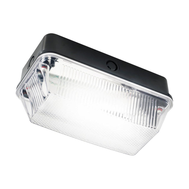 A "60W Outdoor Bulkhead - Black" features a rectangular LED wall pack light, made from durable black polycarbonate with a clear prismatic lens and an elegant design, set against a white background. The light is lit up, highlighting its vibrant glow.