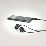 AV:Link EM9B round mini in-ear earphones in black with 3.5mm jack connected to a slim MP3 player on a white background.
