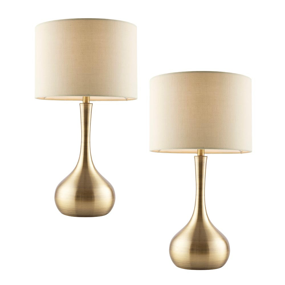 Endon Chartbury LED table lamp twin pack with brass teardrop bases and beige fabric drum shades, shown on a plain white background.