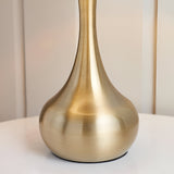 Endon Chartbury LED table lamp base in brushed brass with a curved teardrop shape, shown close-up on a white surface.