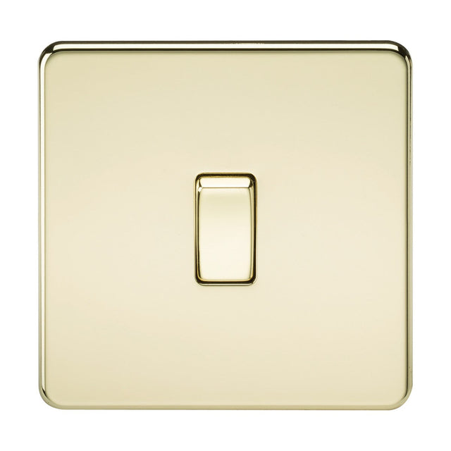 A single polished brass square light switch with a glossy, screwless low profile design, centered on a plain background.