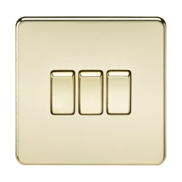 The 10AX 3 Gang 2-Way Switch in a polished brass finish boasts a shiny, smooth appearance and features a sleek, screwless design.