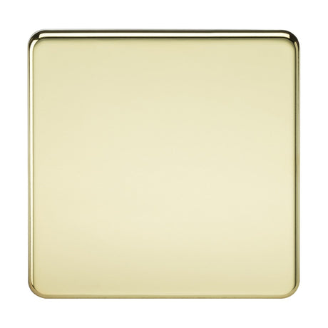 A smooth, square 1 Gang Blanking Plate with rounded corners in polished brass is set against a plain background. Its screwless design and IP20 rating enhance its minimalist appeal, while the glossy brass surface subtly reflects light.