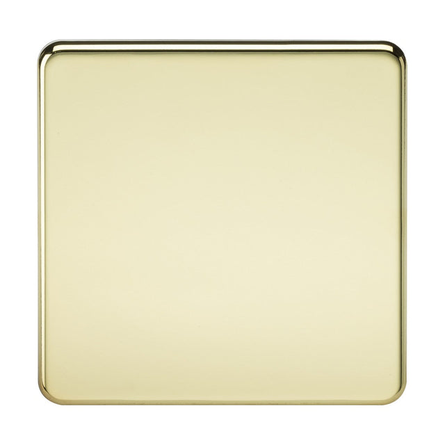 A smooth, square 1 Gang Blanking Plate with rounded corners in polished brass is set against a plain background. Its screwless design and IP20 rating enhance its minimalist appeal, while the glossy brass surface subtly reflects light.