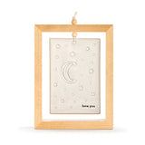 Love You To The Moon Standing Plaque, a rectangular stone-coloured ceramic tile with crescent moon, stars and dots, set in an open brown wood frame on a plain background.