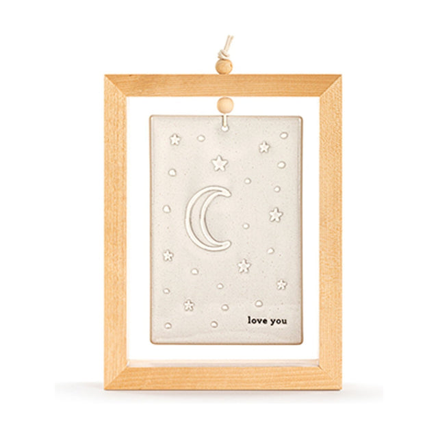 Love You To The Moon Standing Plaque, a rectangular stone-coloured ceramic tile with crescent moon, stars and dots, set in an open brown wood frame on a plain background.