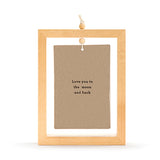 Standing plaque in a light wood open frame with wooden bead and cord hanger, displaying a brown-stone ceramic tile reading "Love you to the moon and back," shown on a plain white background.