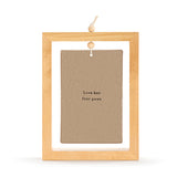 Ceramic standing plaque in a light wood rectangular frame with hanging cord, brown face reading "Love has four paws", shown on a plain white background.