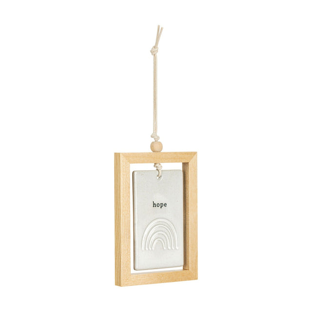 Hope Rainbow Framed Hanging Ceramic Plaque in a light wood frame, with a stone-coloured tile reading "hope" above a raised arched rainbow, hung on a cord against a plain white background.