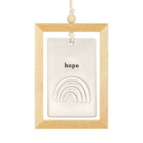 Hope Rainbow Framed Hanging Ceramic Plaque in a light wood frame, with a stone-coloured speckled tile reading "hope" above a raised nested-arch rainbow, on a white background.