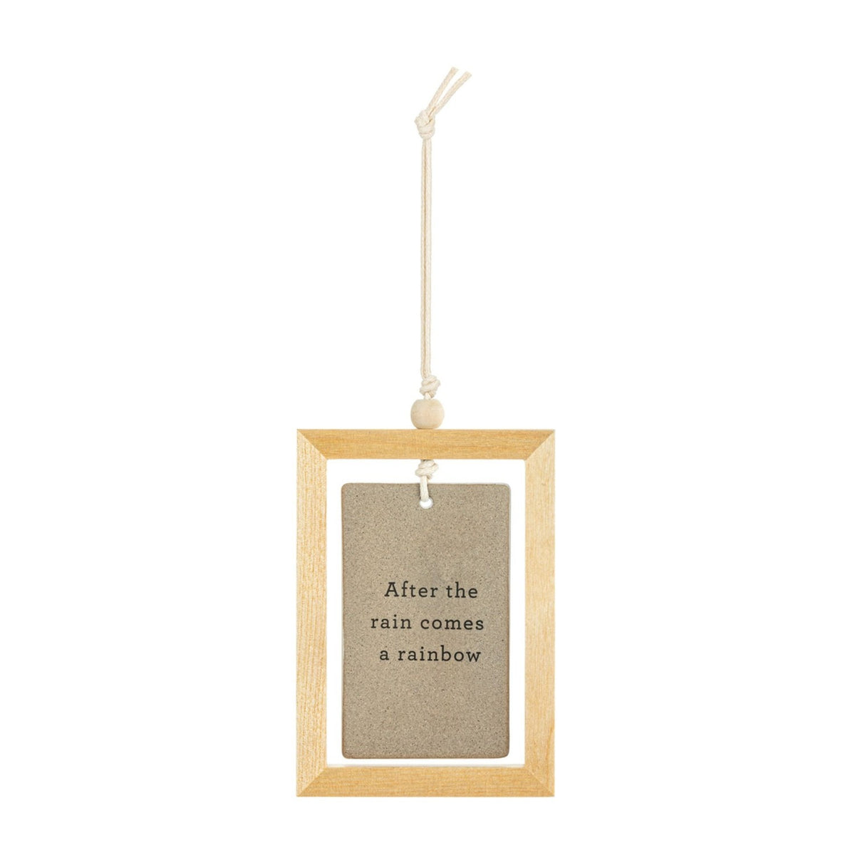 Light wood framed ceramic plaque with stone-coloured tile reading After the rain comes a rainbow, hung on a cord with a wooden bead against a white background.