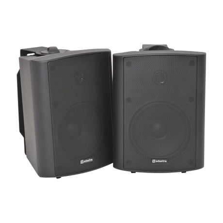 Adastra BC5-B 5.25" two-way background speakers, black pair with perforated grilles and wall brackets, shown on a plain white background.