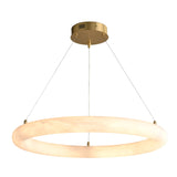 The Seraphis LED Extra Large Alabaster Chandelier - Soft White showcases a glowing ring of natural Spanish alabaster, elegantly suspended by three slender wires from a round gold ceiling mount.