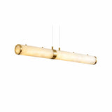 Niori Oria 1m LED linear chandelier with cylindrical Spanish alabaster body, brass end caps and central collar, suspended by two slim cables.