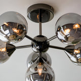 Endon Fitzroy 6 light semi-flush ceiling light in black chrome, viewed from below showing six smoked glass globes on radiating arms from a central sphere.