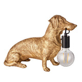 Bevworth Table Lamp: gold resin dachshund figure with black E27 bulb holder holding an exposed filament globe bulb, shown on a white background.