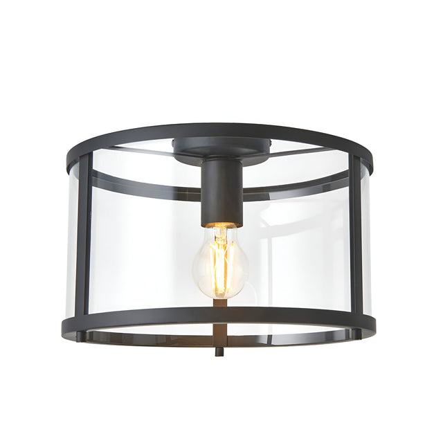 Endon Ellery flush ceiling light in black with a cylindrical clear glass shade and single E27 filament bulb, shown on a plain white background.