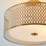 Endon Rosaline 3 Light flush ceiling light in gold, close-up of the drum shade's circular cut-out metal pattern with fabric lining and glass diffuser.
