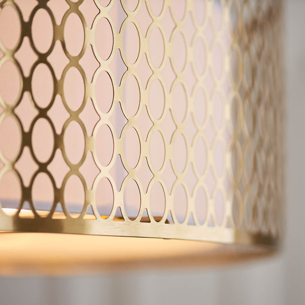 Close-up of the Endon Rosaline flush ceiling light showing its gold metal shade with a geometric circular cut-out pattern and pale fabric inner lining.