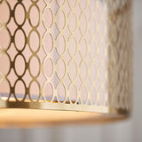 Close-up of the Endon Rosaline flush ceiling light showing its gold metal shade with a geometric circular cut-out pattern and pale fabric inner lining.