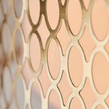 Close-up of the Rosaline 3 Light Pendant's gold metal outer shade, showing a circular geometric fretwork pattern over a pale inner surface.