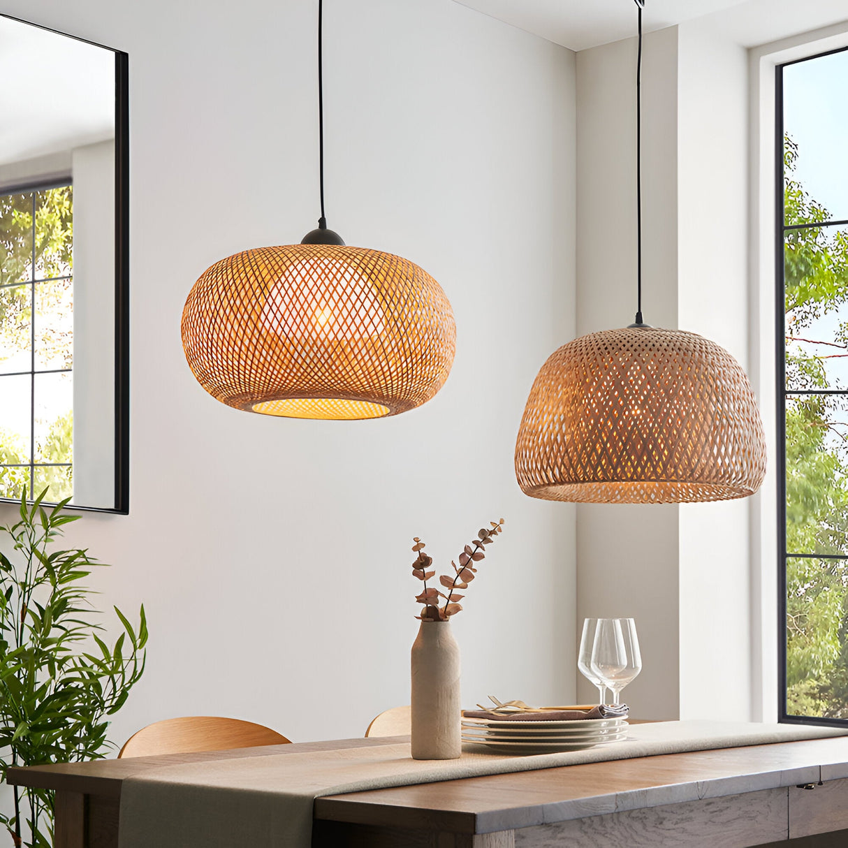 Endon Aldstead Globe Pendant in natural woven rattan with matt black fittings, shown with a domed rattan pendant above a dining table by bright windows.