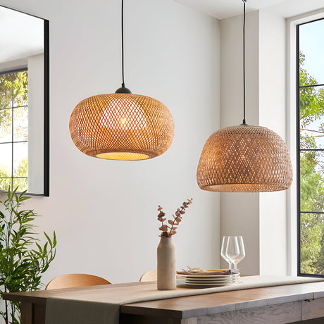 Endon Aldstead Globe Pendant in natural woven rattan with matt black fittings, shown with a domed rattan pendant above a dining table by bright windows.