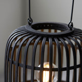Close-up of Endon Bracken table lamp showing black bamboo cage framework, matt black metal top ring, decorative handle, and a warm filament E27 bulb.