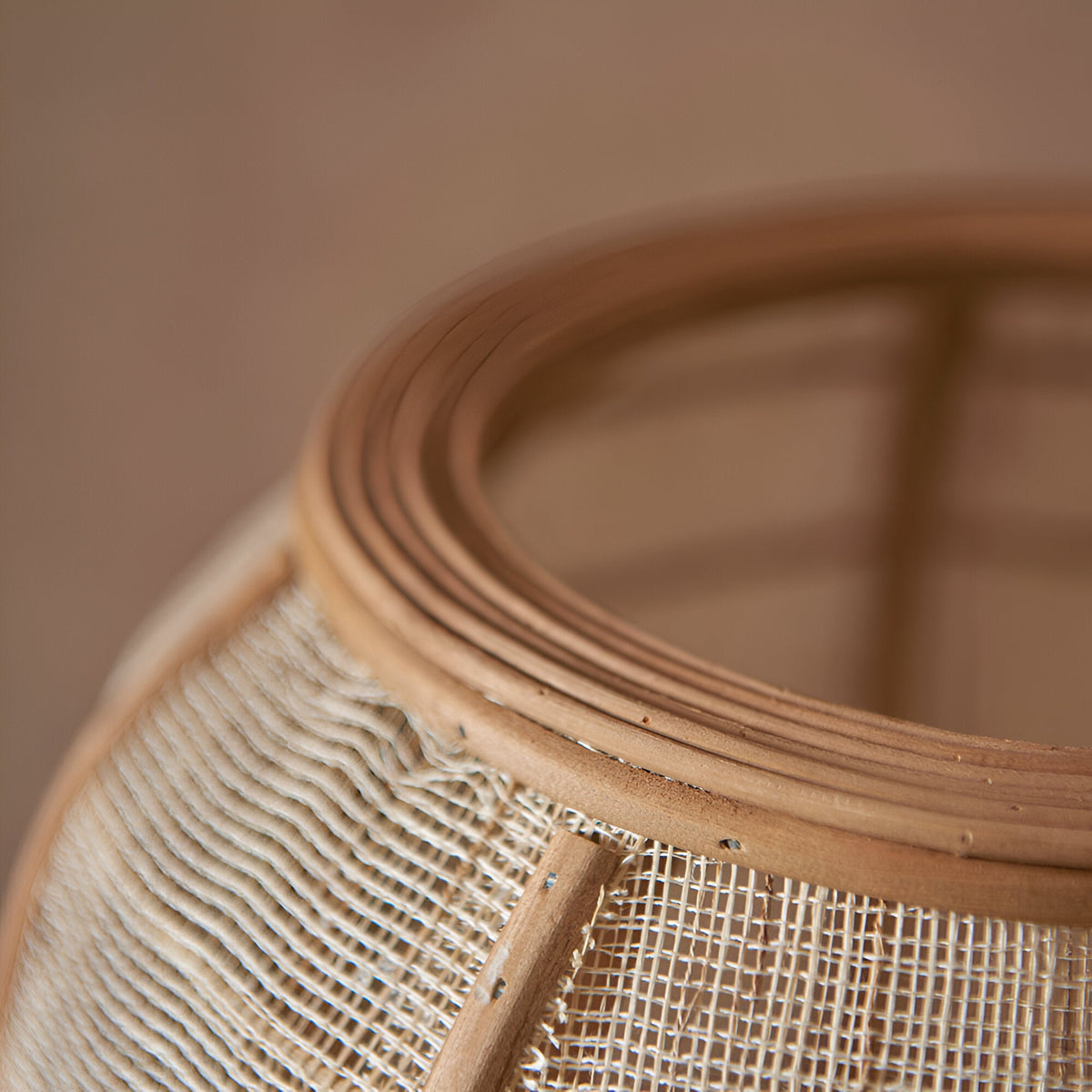 Close-up of the Daneshaw Floor Lamp's shade top, showing woven natural linen fabric over a bamboo frame with a matt black metal ring.