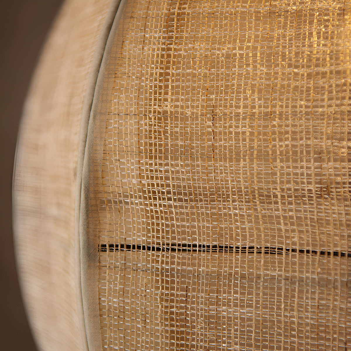 Close-up of the Daneshaw pendant light's natural linen shade with woven texture, showing black metal trim and wood detailing.