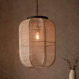 Endon Daneshaw pendant with handmade natural linen shade and matt black top, lit E27 filament bulb, hanging from black flex against a warm earthy wall.