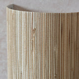 Close-up of the Endon Salcombe wall light showing the woven natural seagrass half-cylinder shade with visible vertical stripes and knotted fibres.