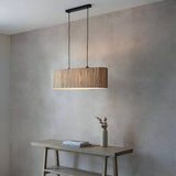 Endon Salcombe 2 light linear pendant with woven natural seagrass oval shade and matt black fittings, hung above a pale wood console table.