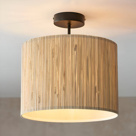 Endon Salcombe semi-flush ceiling light with woven seagrass drum shade and matt black metal fitting, illuminated against a neutral background.