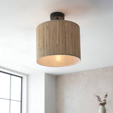 Endon Salcombe semi-flush ceiling light with woven seagrass drum shade and matt black fitting, illuminated on a white ceiling beside a window.