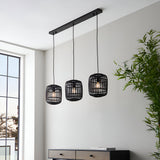 Endon Bracken 3 light linear pendant with black bamboo cage shades and matt black metalwork, hanging above a sideboard in a bright living space.