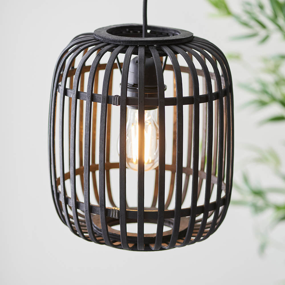 Bracken black bamboo cage pendant light with exposed E27 filament bulb and matt black metalwork, hanging on black flex.