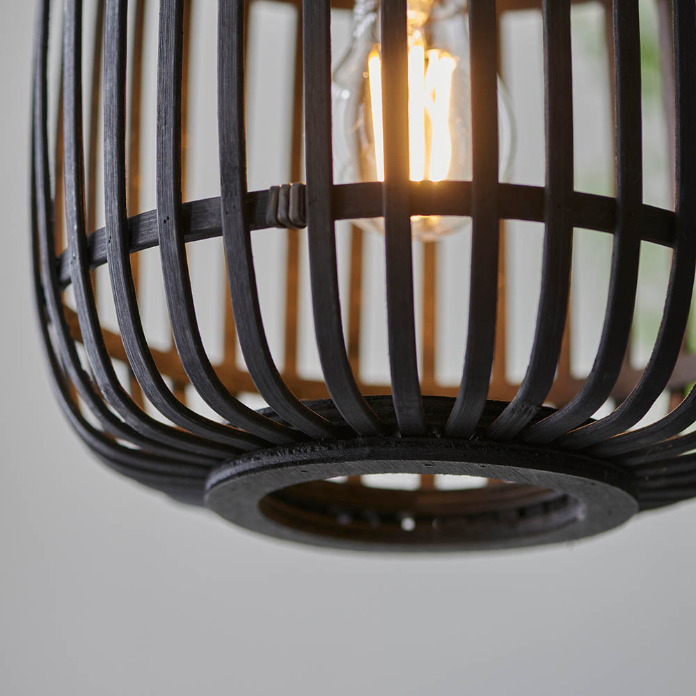 Close-up of the Bracken Pendant Light in black, showing an open bamboo cage shade with matt black metal fittings and a visible E27 filament bulb.