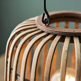 Close-up of Endon Bracken table lamp showing the natural bamboo cage framework, matt black metal handle and hook detail against a soft green background.