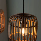 Close-up of Endon Bracken pendant light showing a lit E27 filament bulb inside an open natural bamboo cage shade with matt black fittings.