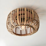 Endon Bracken bamboo flush ceiling light in a natural finish, with a rounded woven shade and single E27 lamp, mounted to a white ceiling.