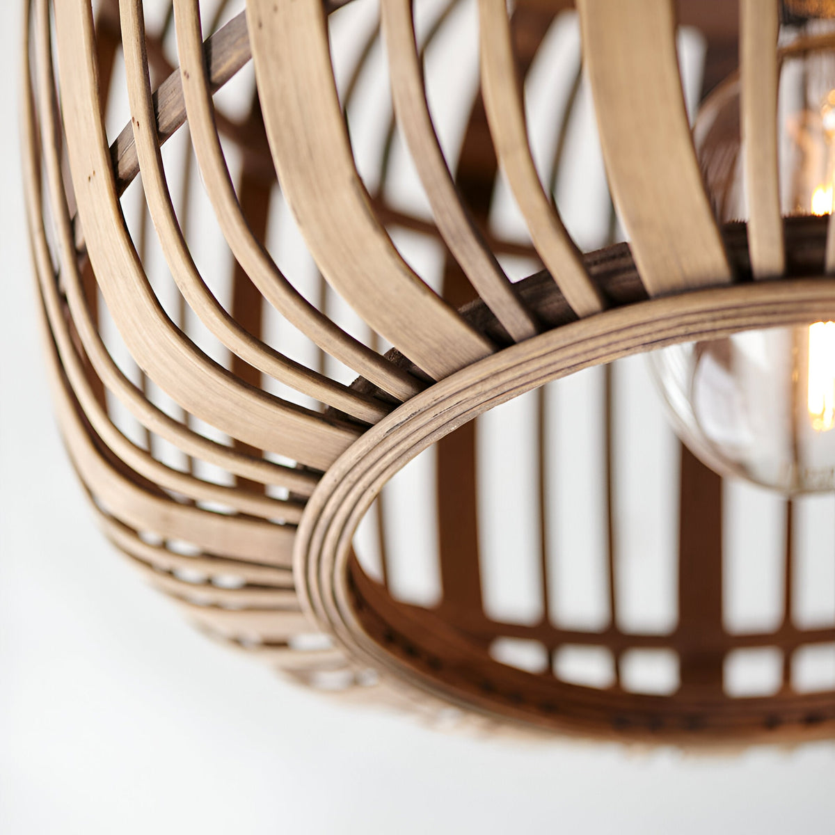 Close-up of Endon Bracken flush ceiling light showing woven natural bamboo shade slats and E27 lamp glowing softly within.