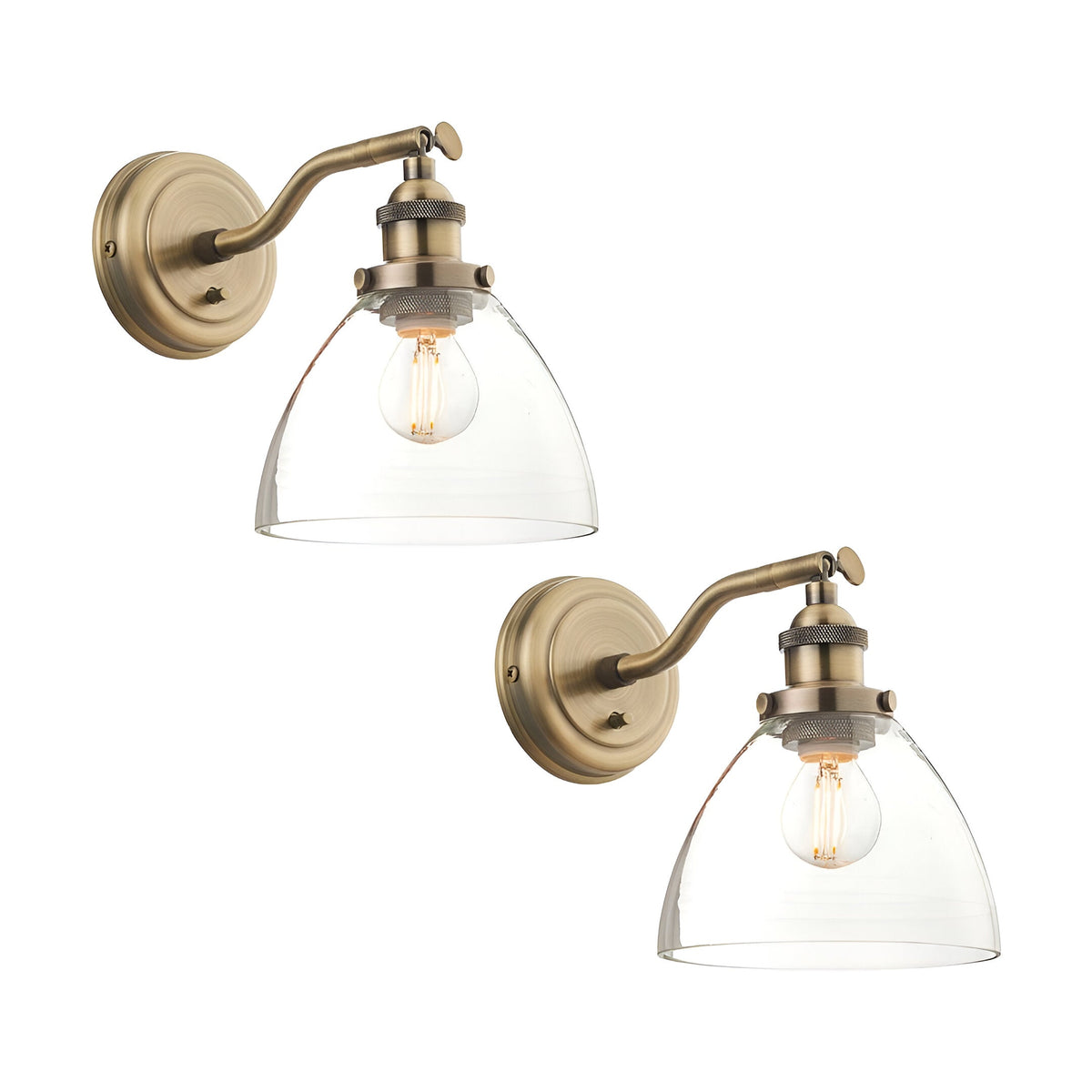 Wentworth Wall Light in antique brass, twin pack, each with an adjustable knuckle arm, curved backplate, clear dome glass shade and filament bulb, shown on a white background.