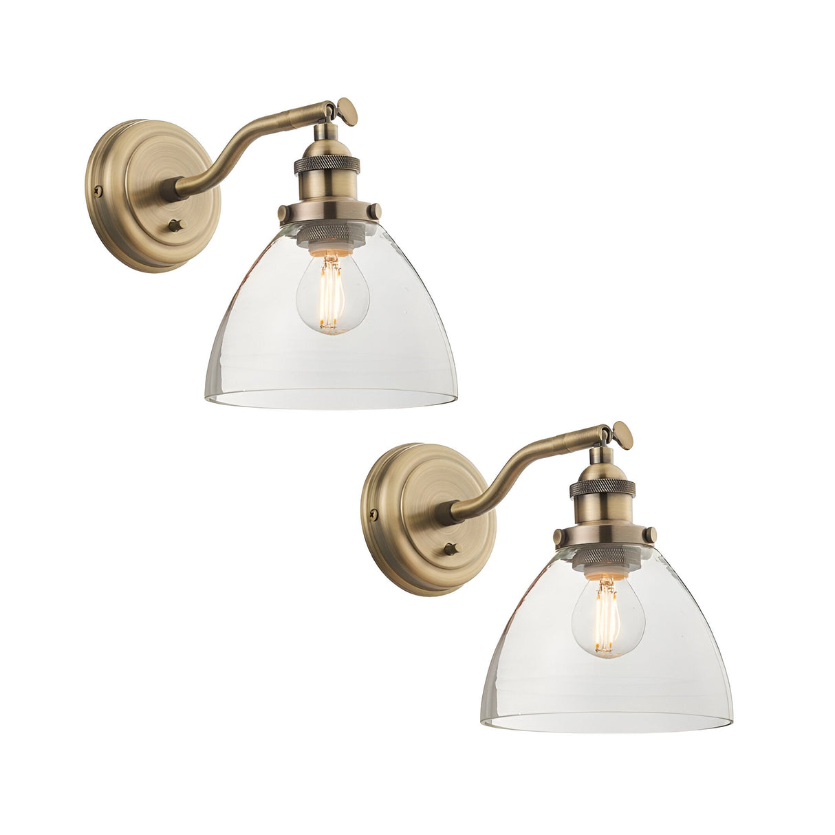 Wentworth Wall Light in antique brass, twin pack shown, each with an adjustable arm, knurled fitting, and clear glass dome shade over a filament bulb, on a plain white background.