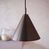 Endon Ashworth cone pendant light in brushed antique bronze with a black fabric cable, hanging above a kitchen counter with a glass jar.