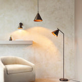 Endon Ashworth bronze wall light with a small conical shade and adjustable arm, illuminated beside a pendant and floor lamp above a shelf and armchair.