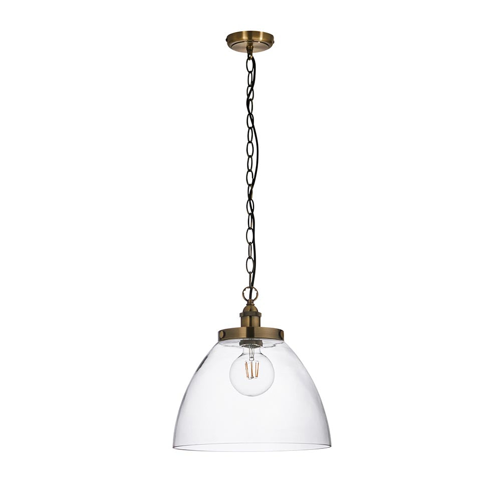 Wentworth Pendant in antique brass with a clear glass dome shade, knurled lampholder, and black chain, shown on a plain white background.