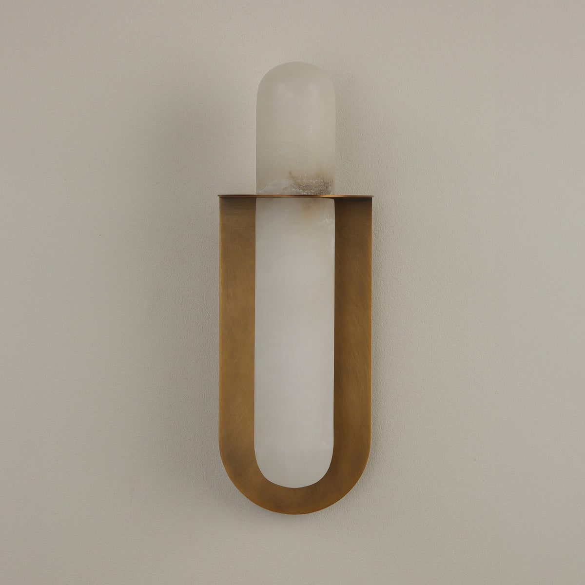 Luneth LED Large Alabaster Wall Light in brushed brass, with a vertical natural alabaster rod cradled in a U-shaped backplate, shown against a plain light grey background.